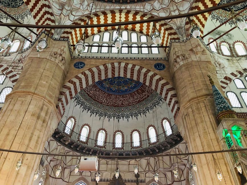 The vast domed interior of the Selimiye Mosque in Edirne, light streaming through ringed windows