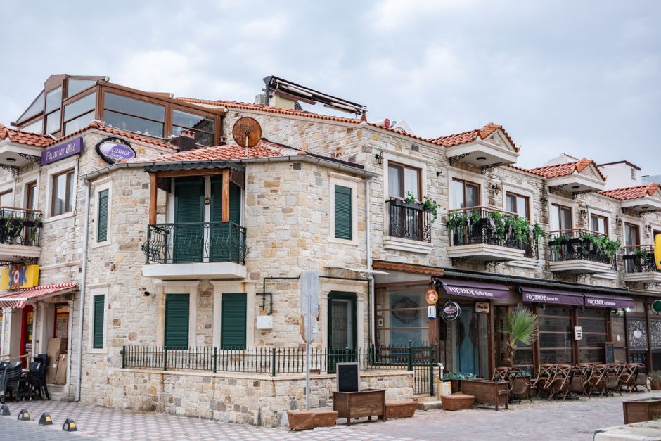 A stone Greek Orthodox village on Gökçeada with an old church bell tower