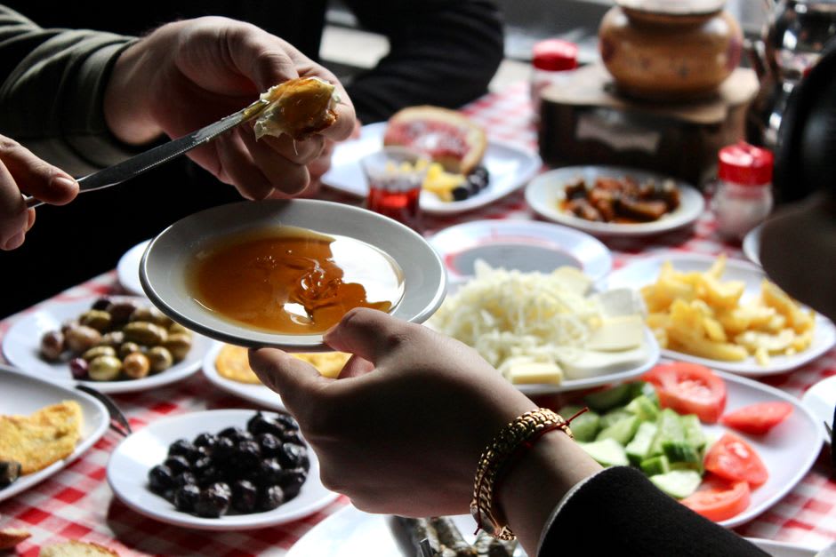 A spread of local kaşar cheese, honey, and butter served for breakfast at a Kars lokanta