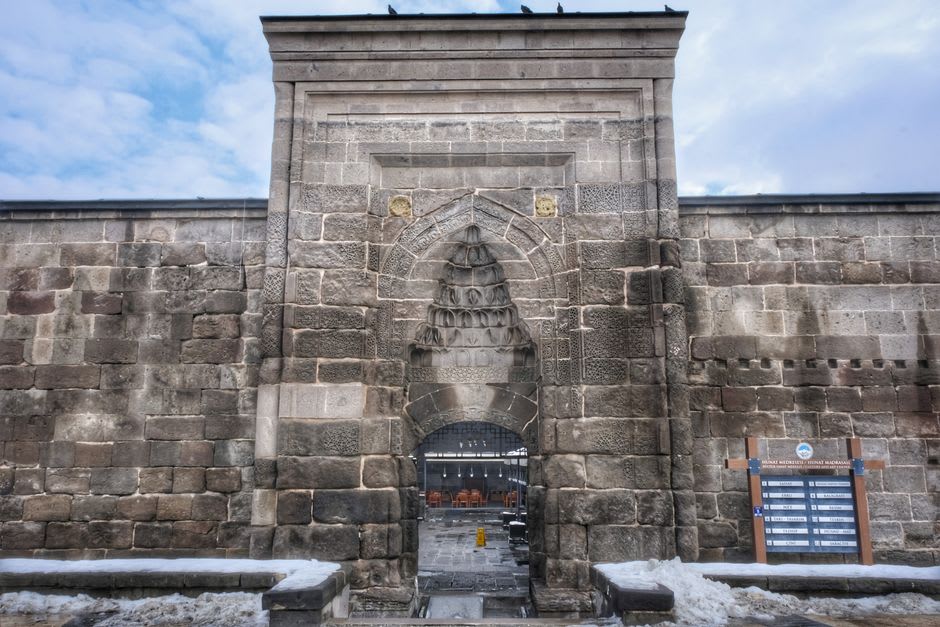 The black basalt walls of the Seljuk citadel in Kayseri with Mount Erciyes behind