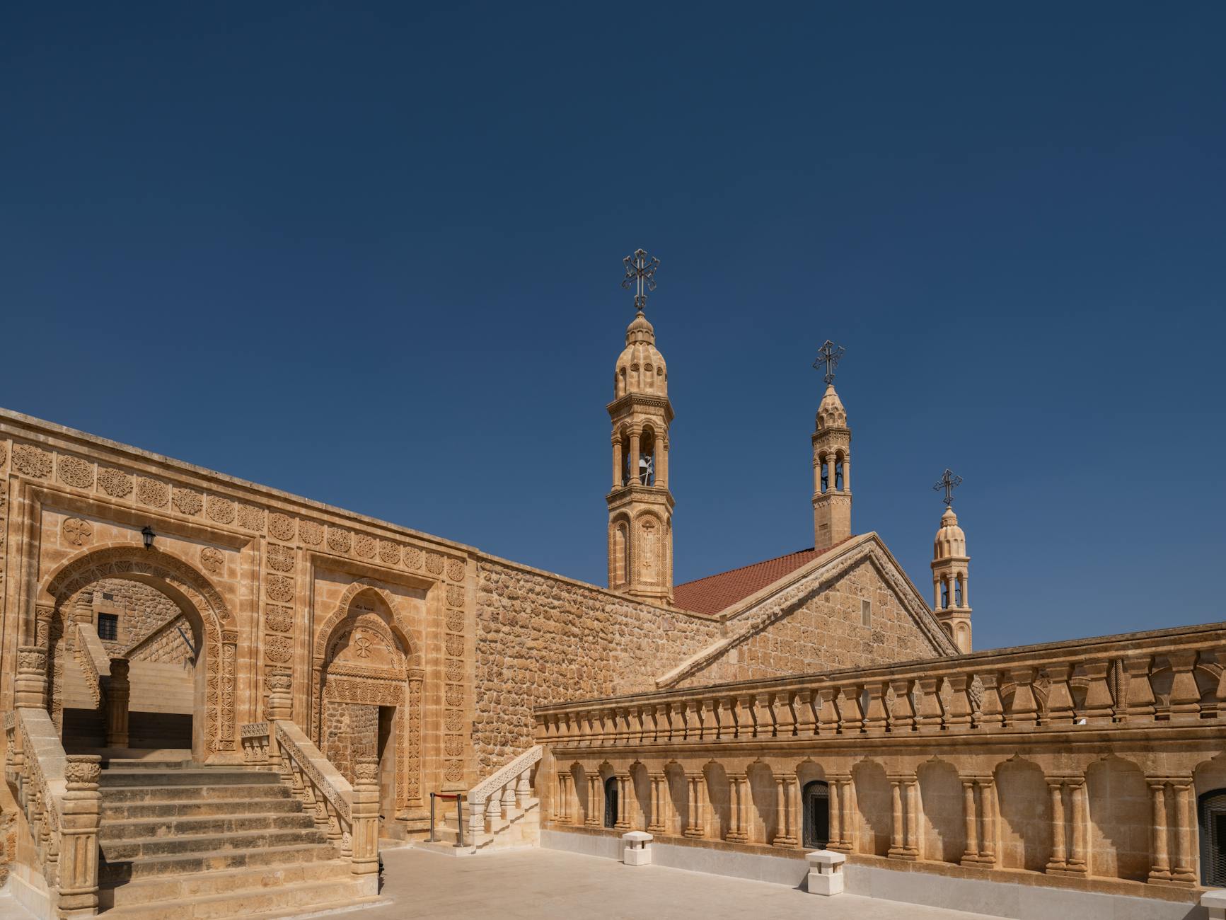 An ancient monastery with stone arches overlooking the Mesopotamian landscape