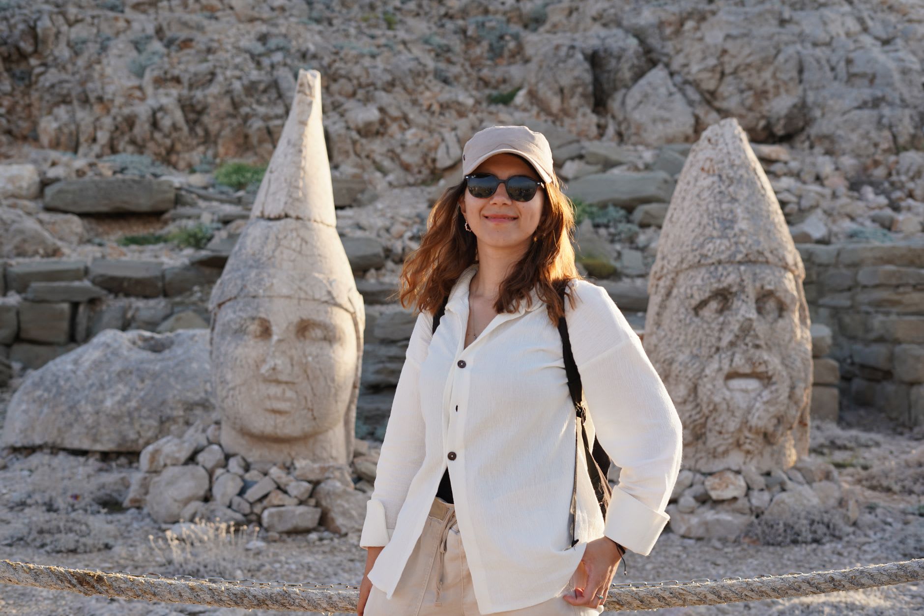 Colossal limestone heads of gods and kings arranged in a row on the East Terrace of Mount Nemrut, their worn faces glowing in the pale pre-dawn light