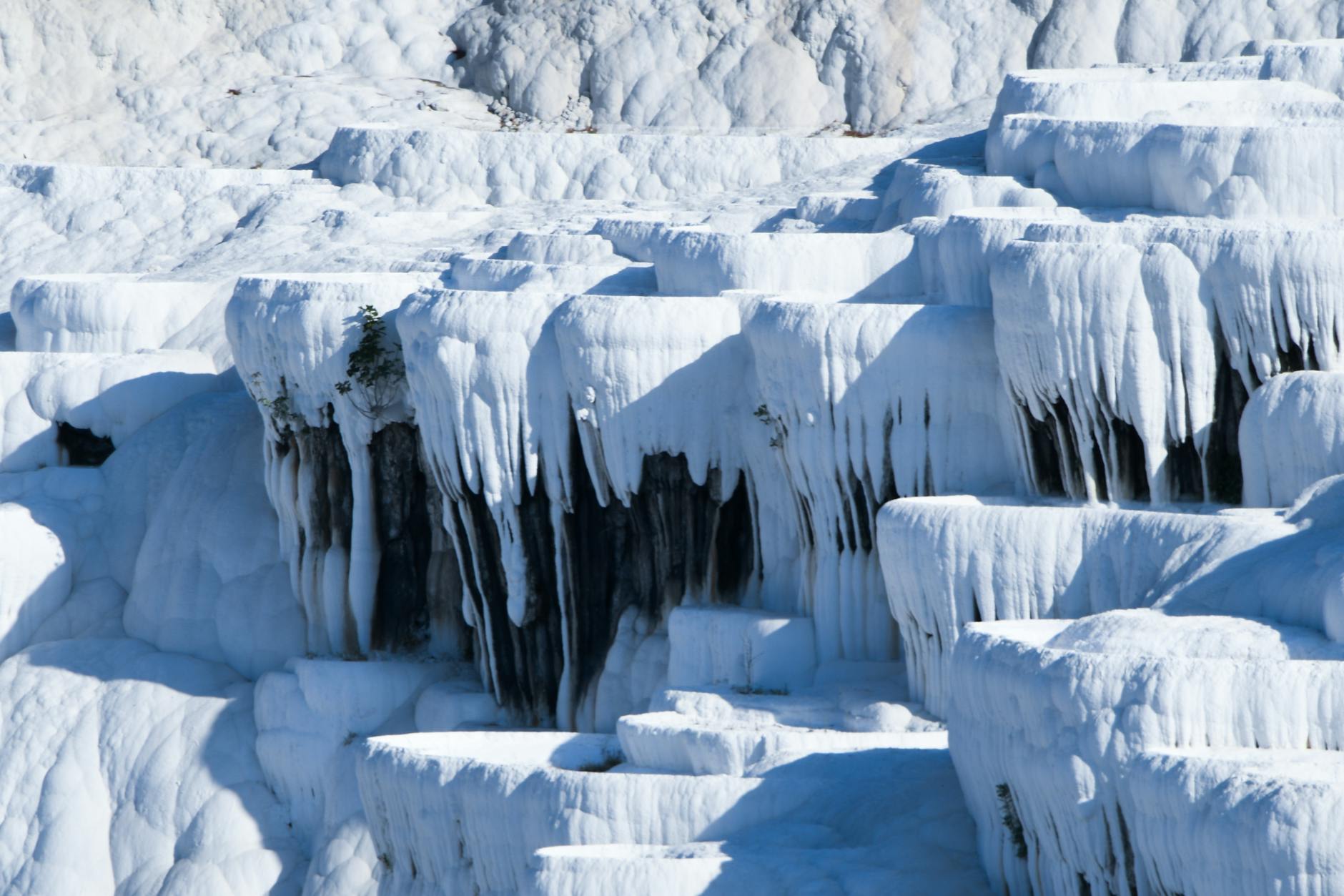 The gleaming white travertine terraces of Pamukkale filled with thermal water