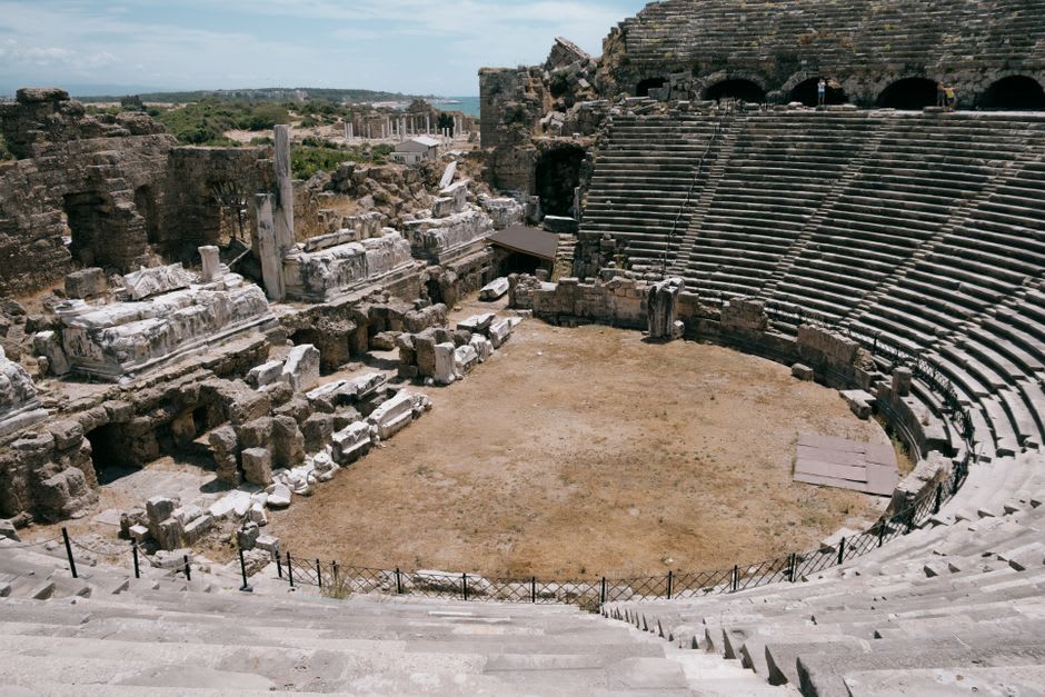 Roman ruins of the ancient theater at Side with the modern town visible beyond