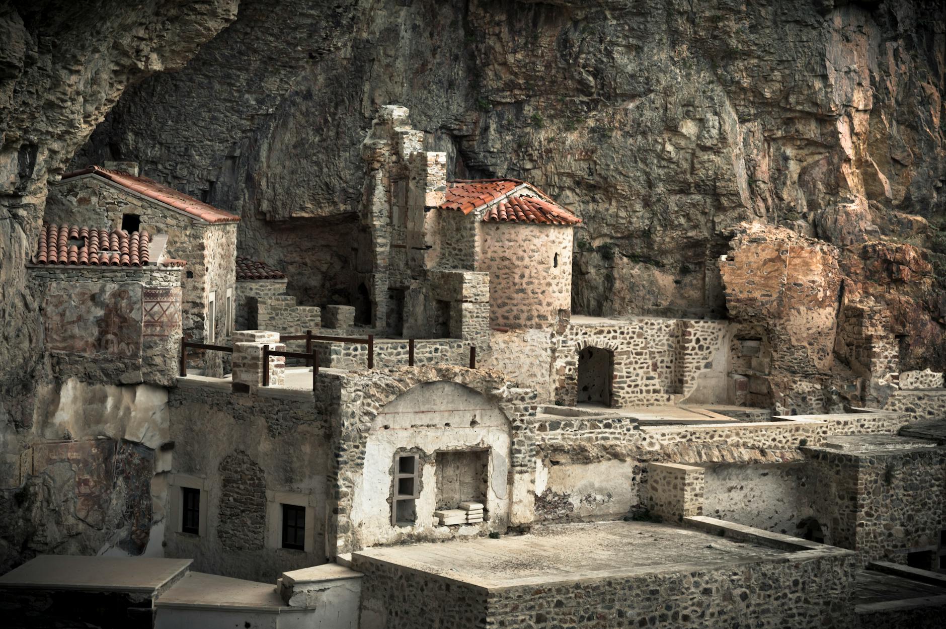 The Sumela Monastery carved into the misty cliff face above the forest
