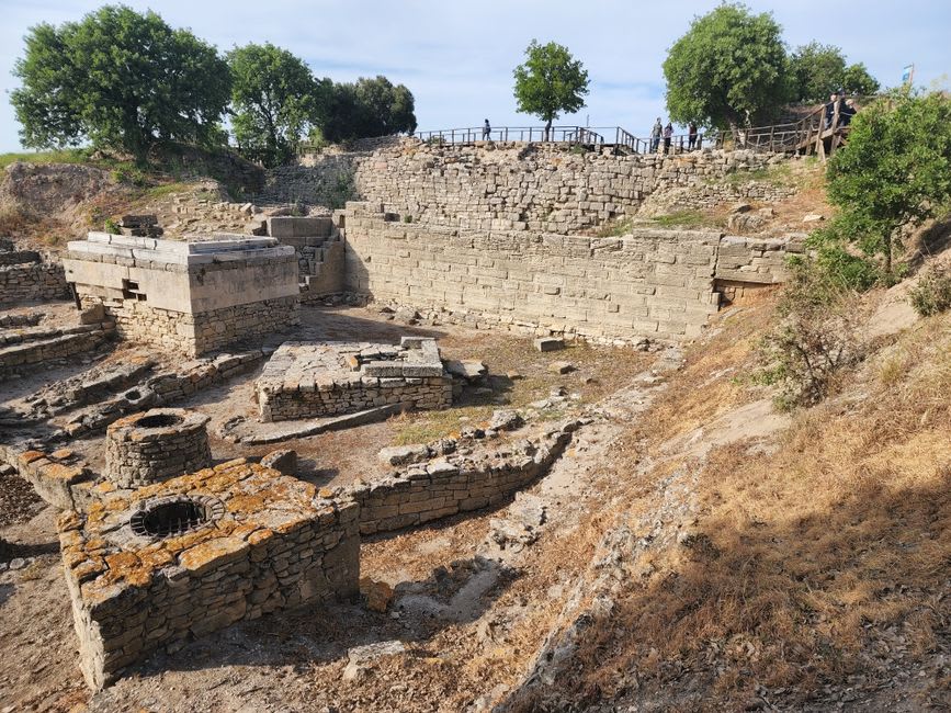 Ancient stratified stone walls at the Troy excavation site, layers of different eras visible in the rock