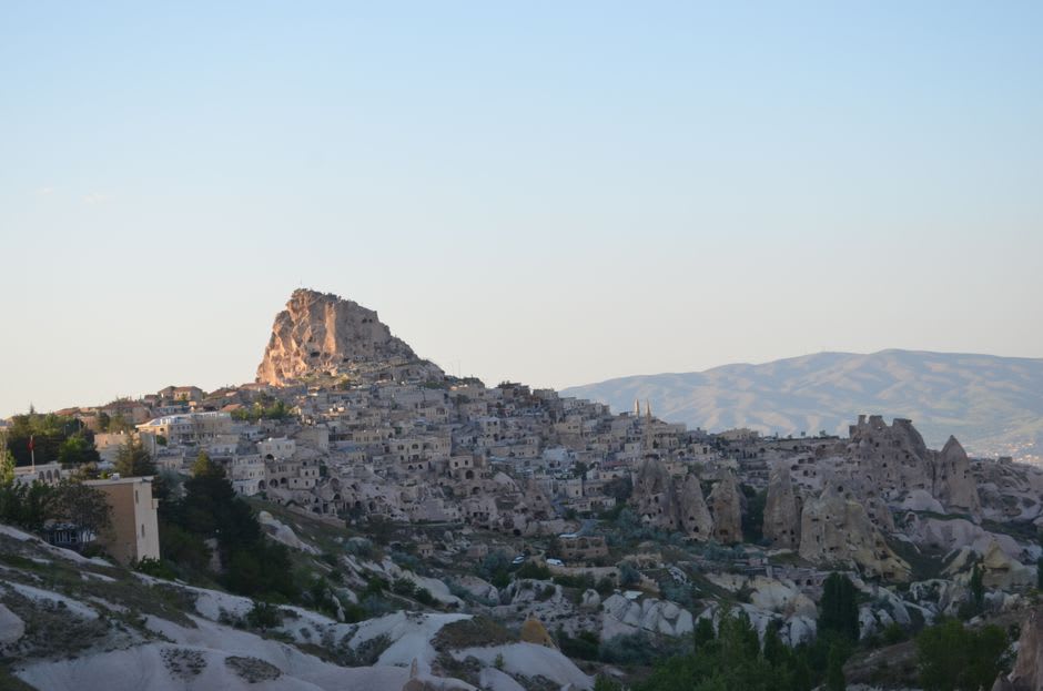 The honeycombed rock face of Uchisar Castle riddled with carved windows and doorways