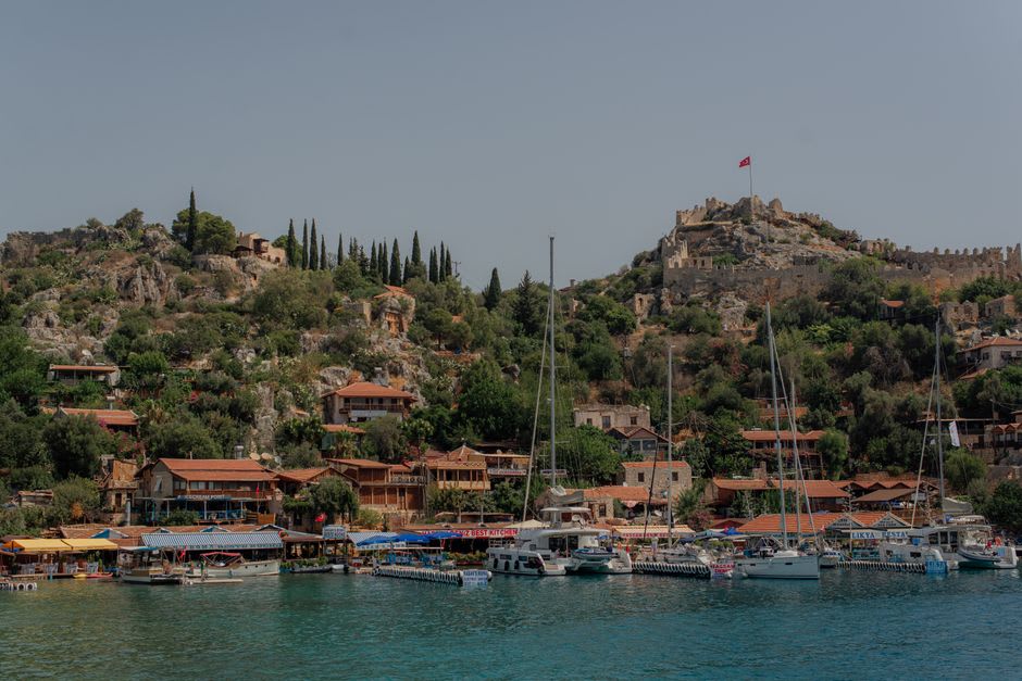 Ancient stone foundations and steps of the sunken city visible beneath shallow turquoise water near Kekova island