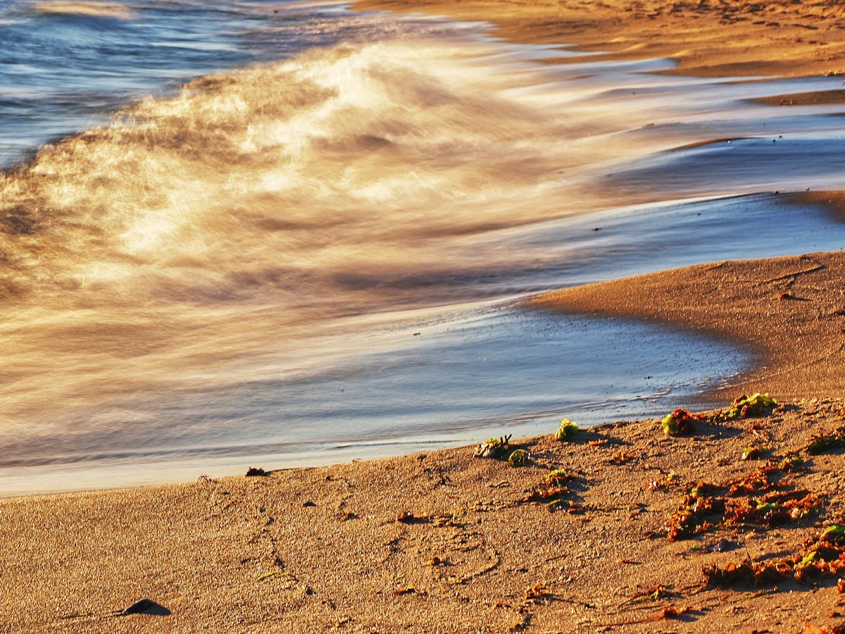 Uncrowded beach along the Ajman Corniche at golden hour