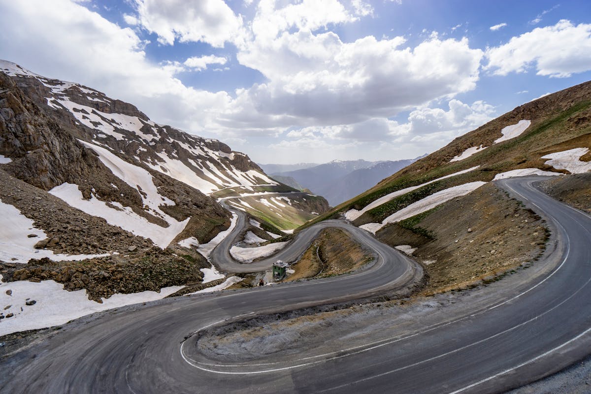 Rocky mountain road winding up Jebel Hafeet at sunset