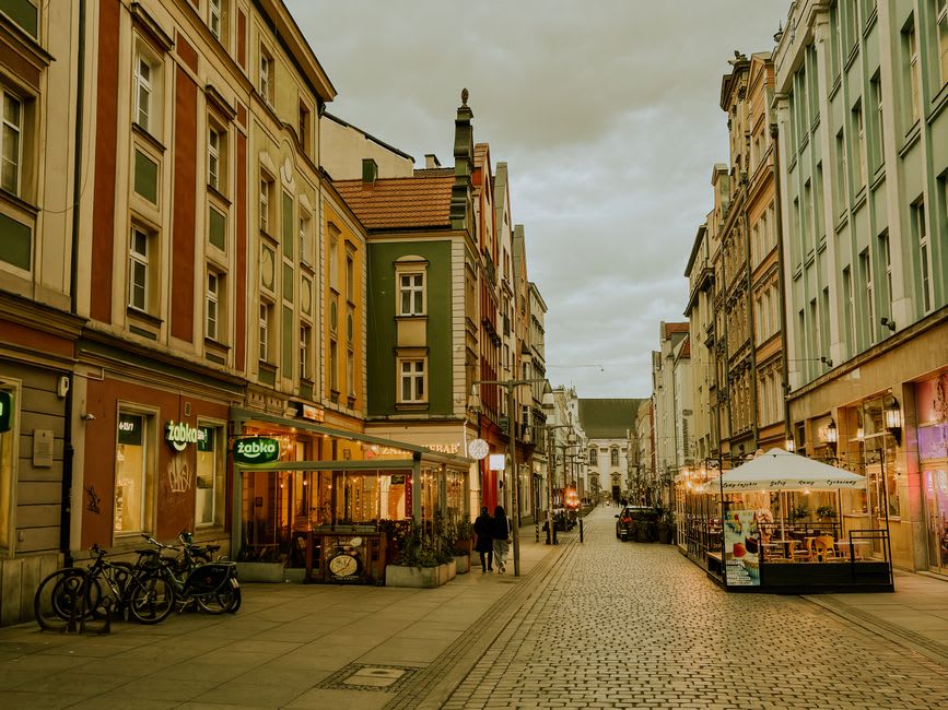 Pedestrian boulevard at City Walk lined with cafes and boutique storefronts at dusk