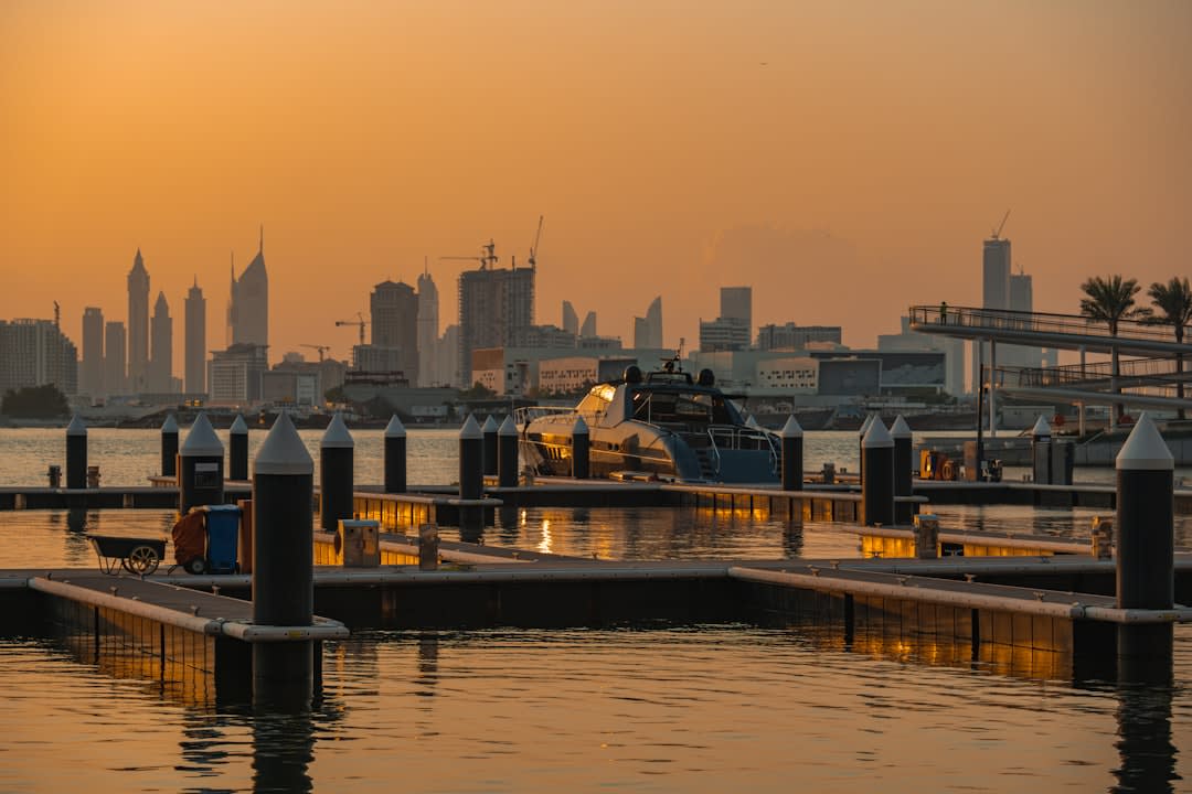 An abra water taxi crossing the calm water of Dubai Creek at dusk