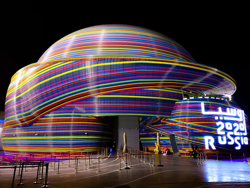 Al Wasl Dome lit up with a colorful projection show against the night sky