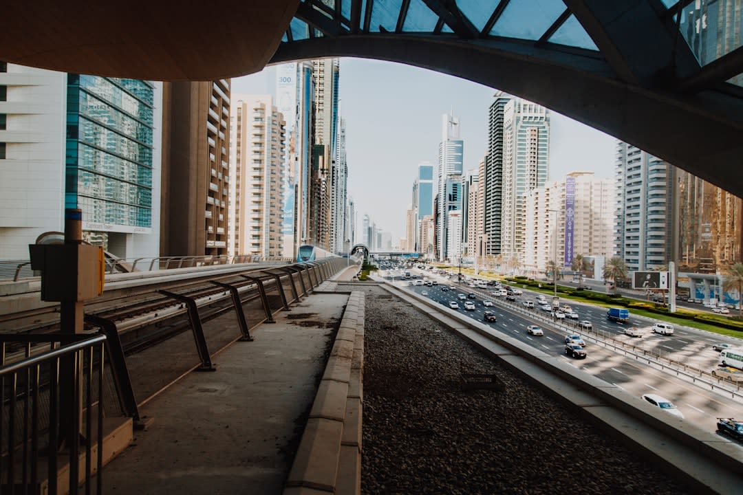 View through the Dubai Frame's glass floor skywalk looking down toward Zabeel Park