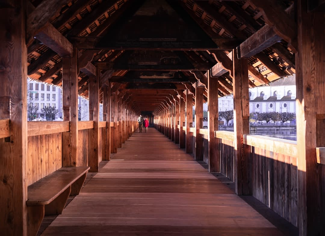 Covered wooden archway of Dubai Gold Souk lined with jewelry shops in the evening