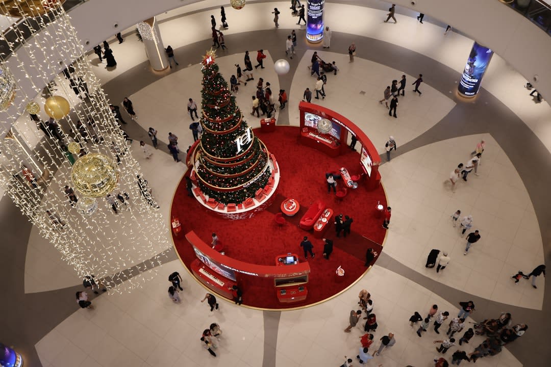 Skaters gliding across the full-size ice rink at the center of Dubai Mall