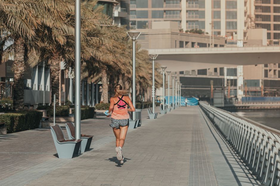 Promenade along the Dubai Water Canal near La Mer with colorful beachfront buildings