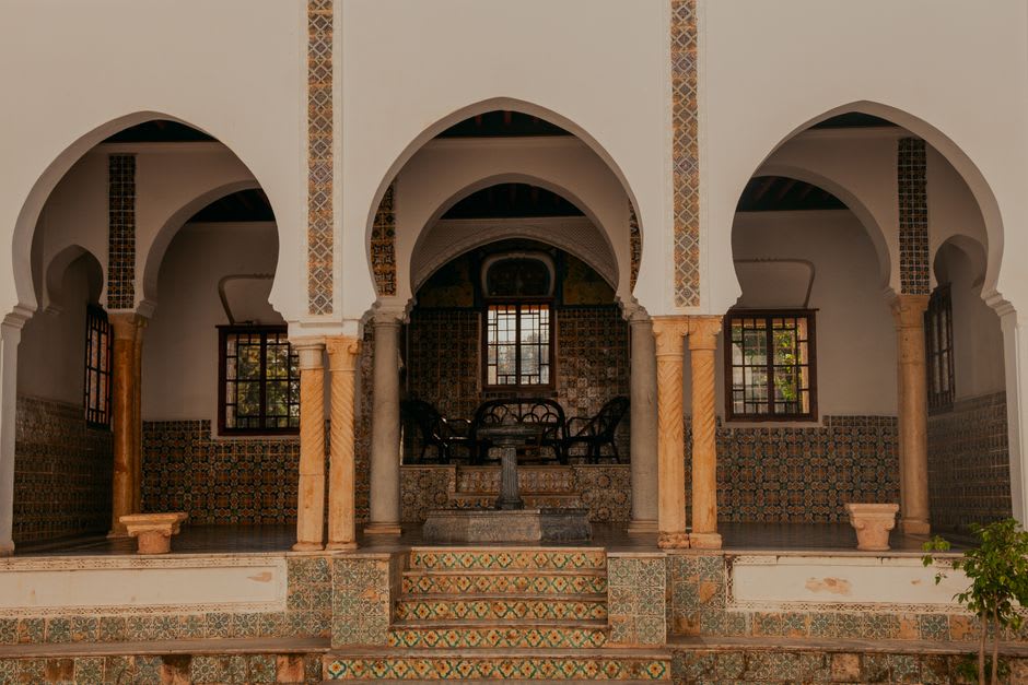 Themed courtyard architecture with tiled archways in one of International City's residential clusters