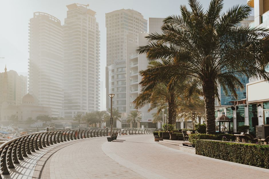 The Walk promenade at JBR lined with cafes and palm trees at sunset