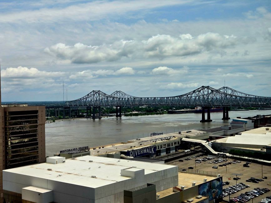 The grey steel hull of the USS Kidd destroyer moored on the Mississippi levee