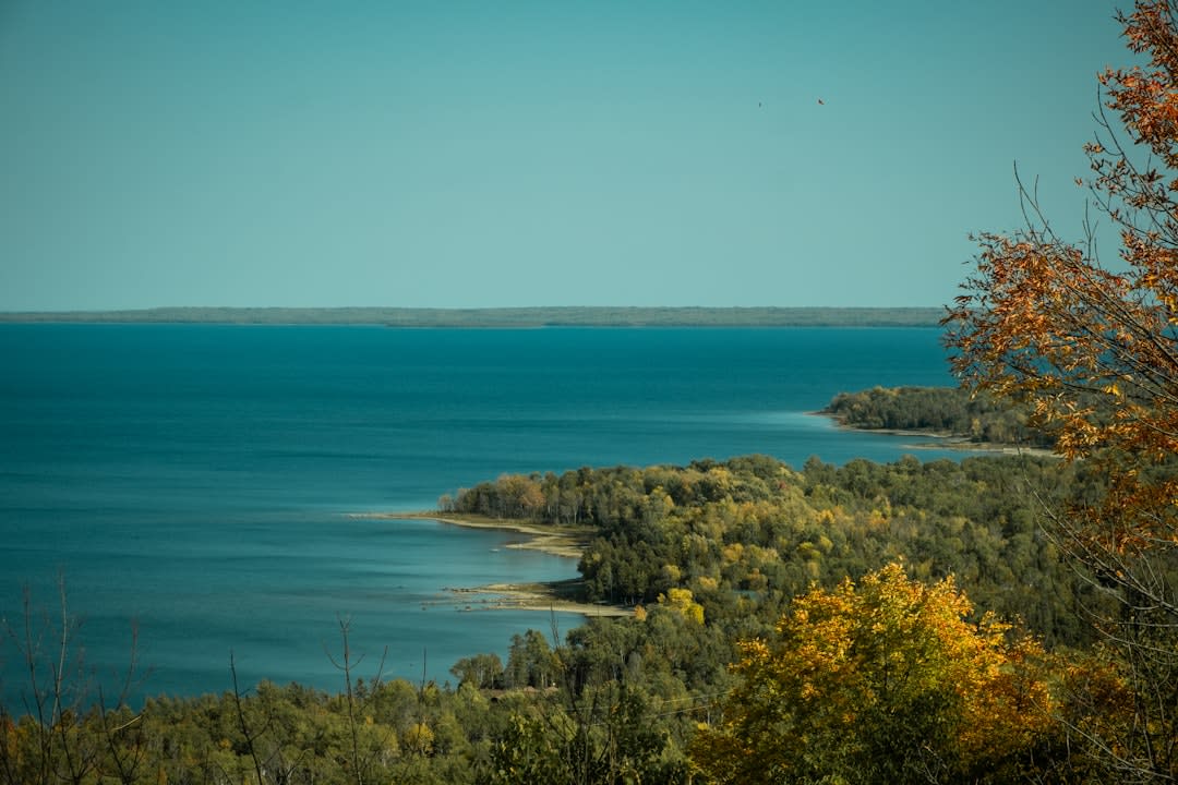 Canoeing on the calm, forested shoreline of Lake Metigoshe near Bottineau, North Dakota