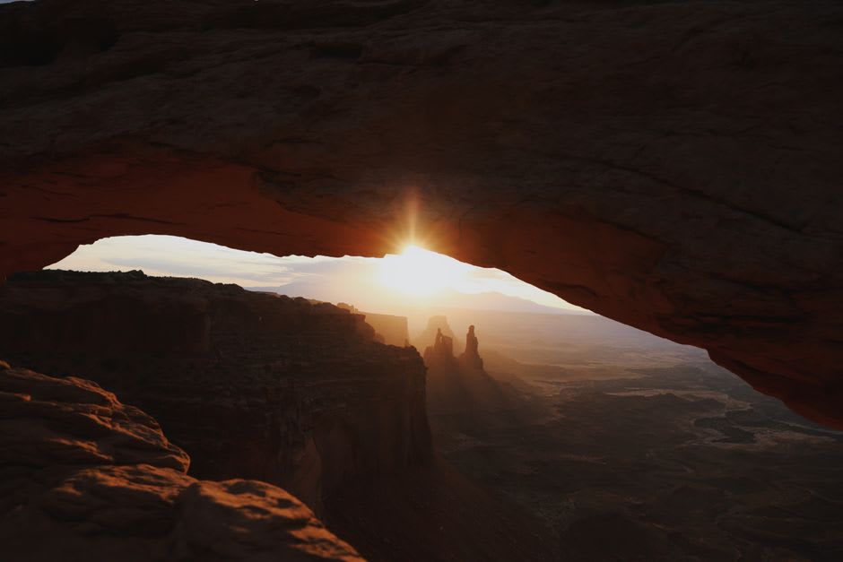 Sunrise glowing under Mesa Arch at Island in the Sky