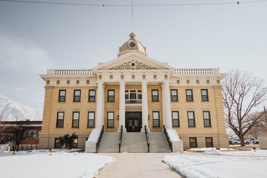 The ornate marble facade and clock tower of the Jasper County Courthouse in Carthage, Missouri