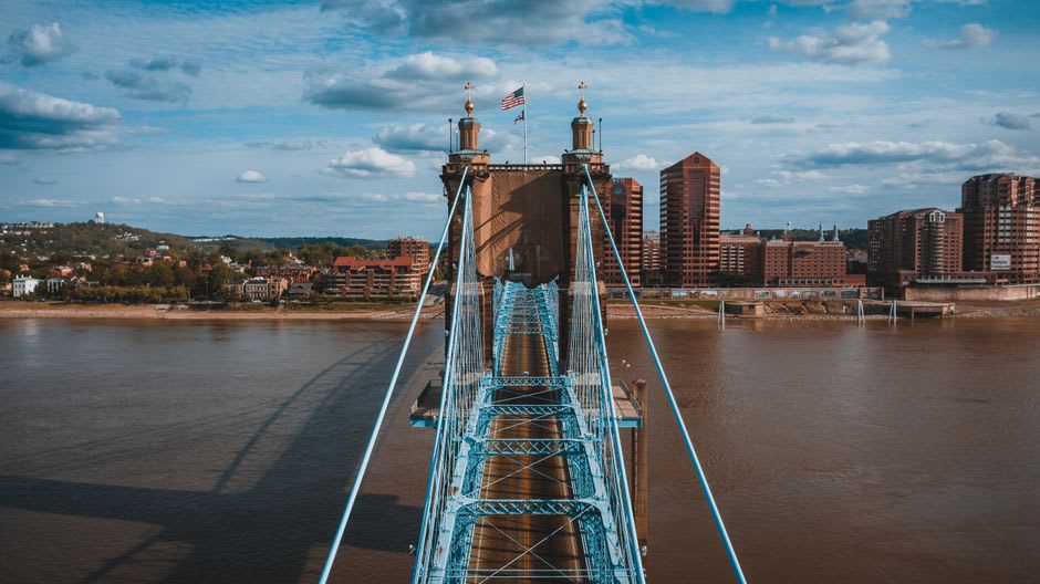The blue towers and cables of the Roebling Suspension Bridge over the Ohio River