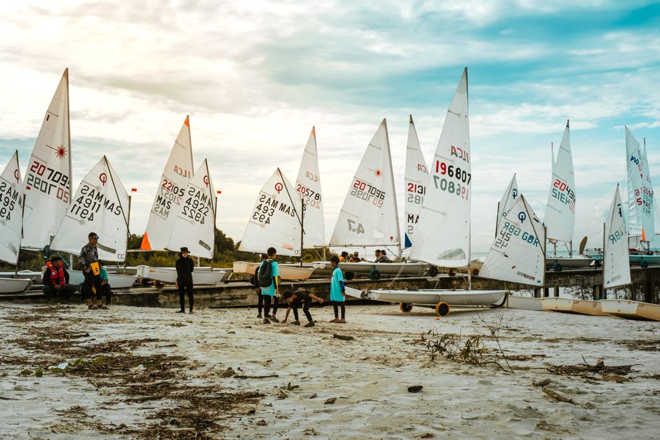 Families and sailboats along the sandy public beach on Clear Lake, Iowa