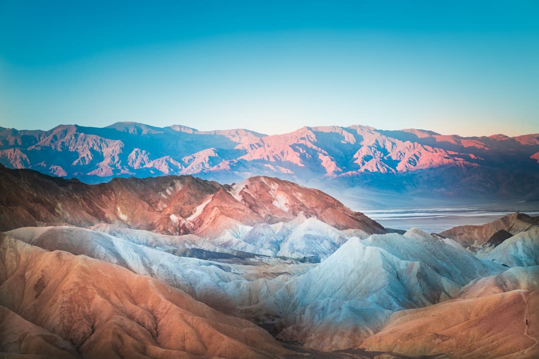 The green, pink and gold mineral-stained slopes of Artist's Palette in warm afternoon light