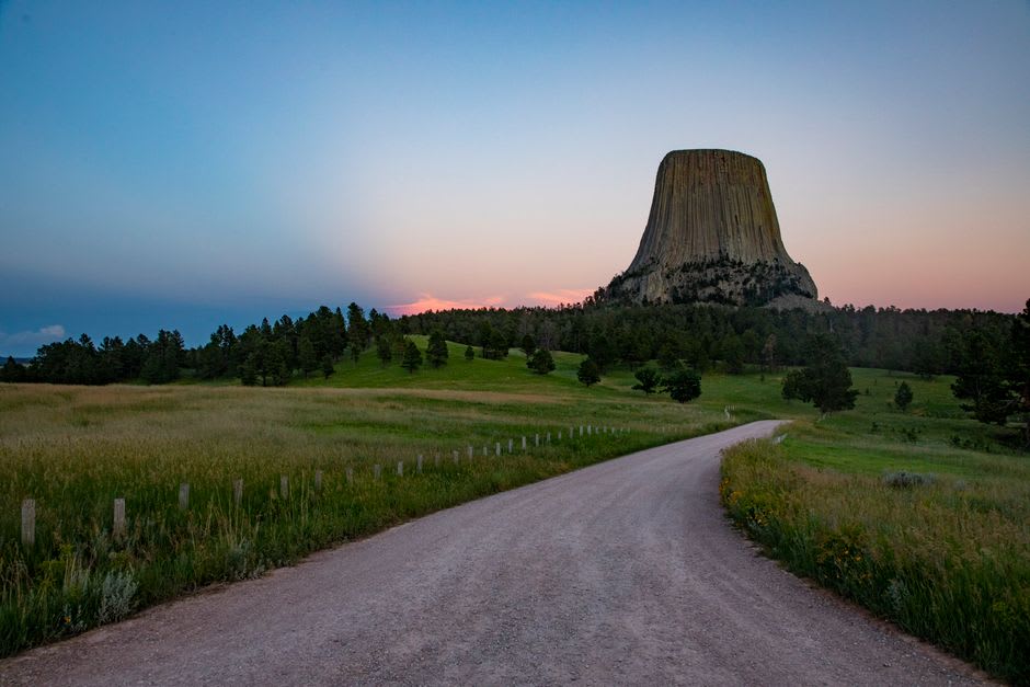 Two rock climbers ascending a vertical crack on the columns of Devils Tower