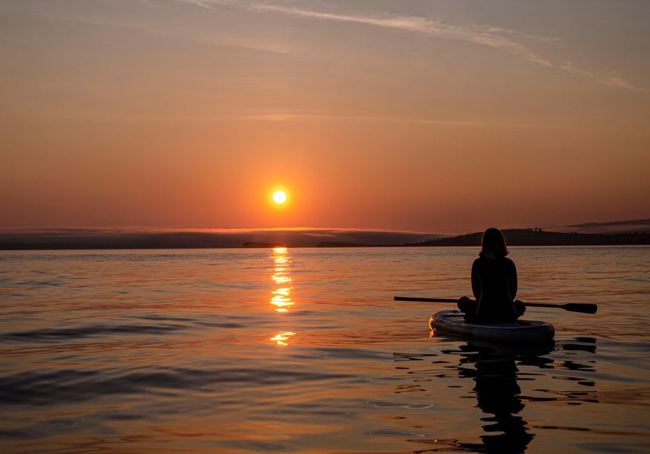A kayak on the calm, sunset-lit waters of Rehoboth Bay off Dewey Beach, Delaware