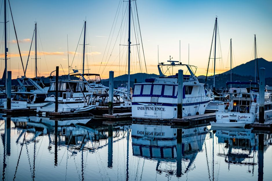 Sailboats moored in Greenwich Bay at sunset near the town dock in East Greenwich, Rhode Island