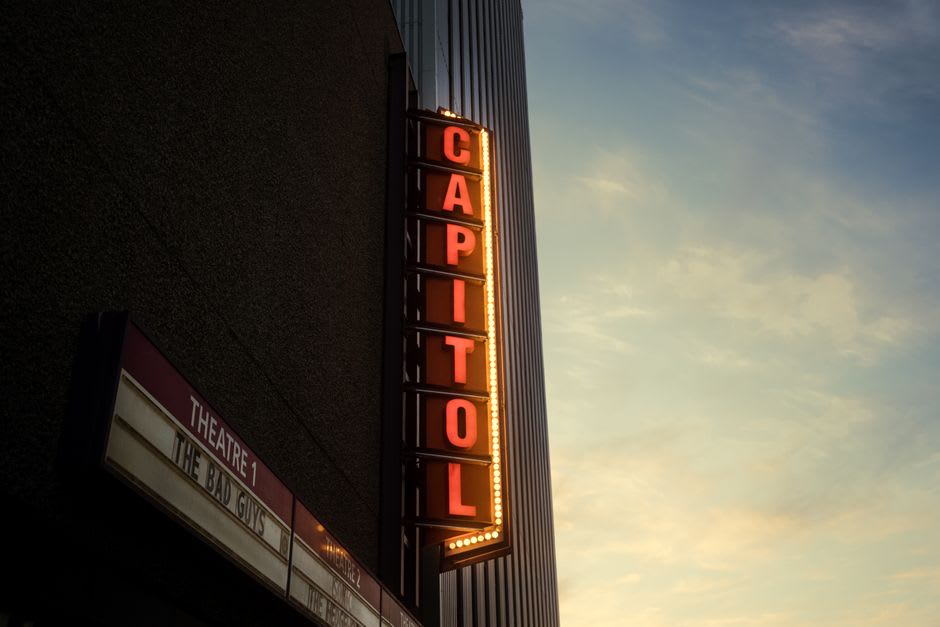 The restored Art Deco Rialto Theater marquee glowing at dusk in downtown El Dorado, Arkansas