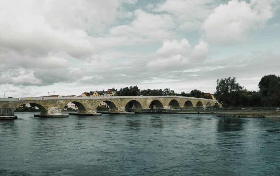 The historic limestone Keystone Bridge arching over the Turkey River in Elkader, Iowa