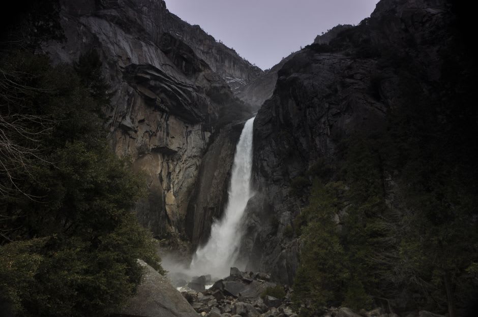 Mist rising off a waterfall inside the narrow granite walls of the Flume Gorge near Franconia, New Hampshire