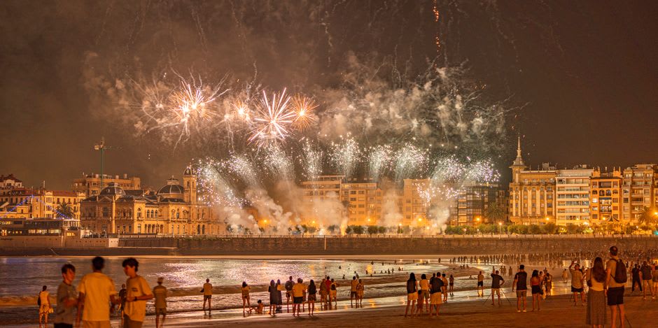 Fireworks bursting over the ocean above the crowded boardwalk at Hampton Beach, New Hampshire