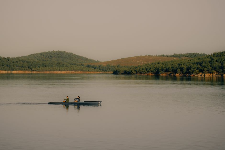 A canoe gliding down the calm, tree-lined Lackawaxen River near Honesdale, Pennsylvania