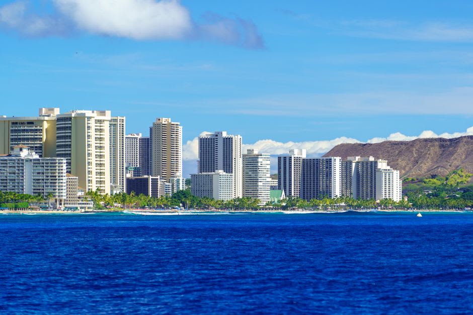 Surfers and swimmers in the gentle shorebreak at Waikiki Beach