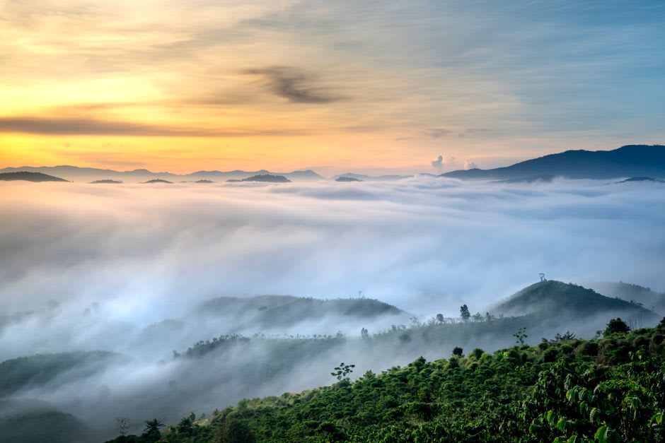 Sunrise light over misty valleys seen from the granite summit of Mount Monadnock near Jaffrey, New Hampshire