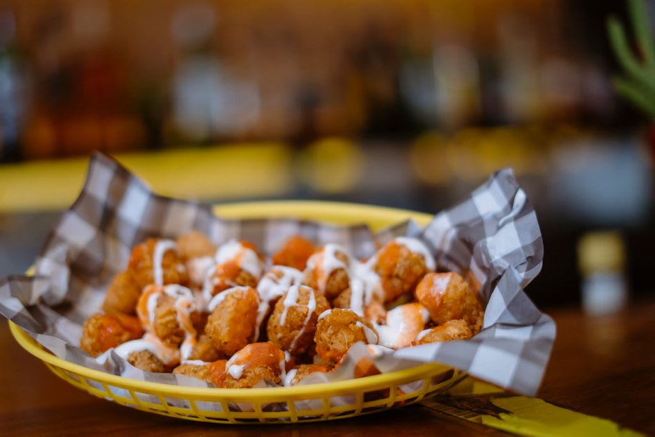 A plate of fried catfish, hushpuppies, and hot tamales at a Delta diner in Jonesboro, Arkansas