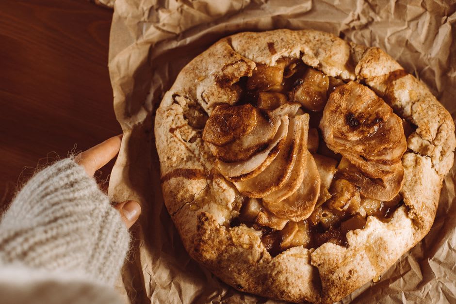 A warm slice of apple pie with a flaking crust on a plate in Julian