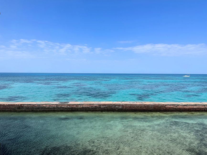 A colorful sailboat on turquoise water off the coast of Key West