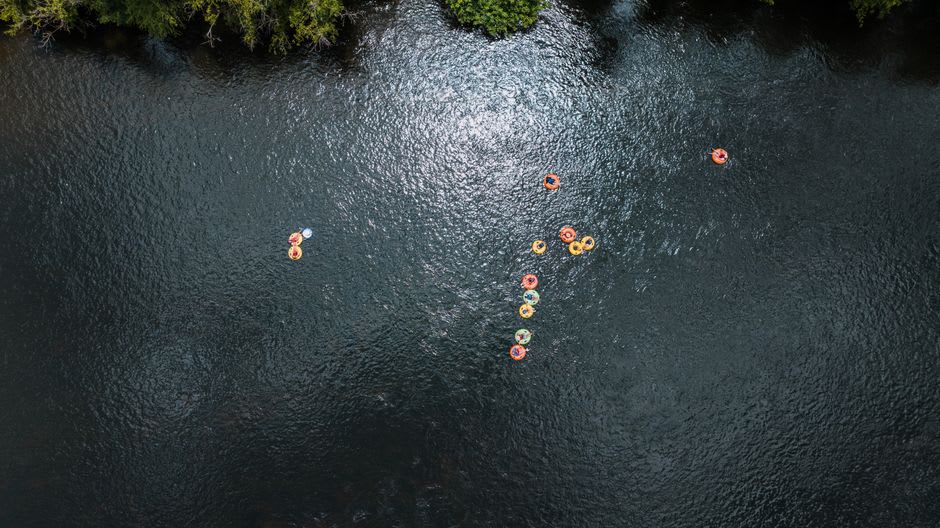 People floating on inner tubes down the Colorado River past casino towers in Laughlin, Nevada