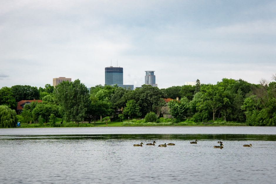 The Stone Arch Bridge curving across the Mississippi River past old flour mills in Minneapolis