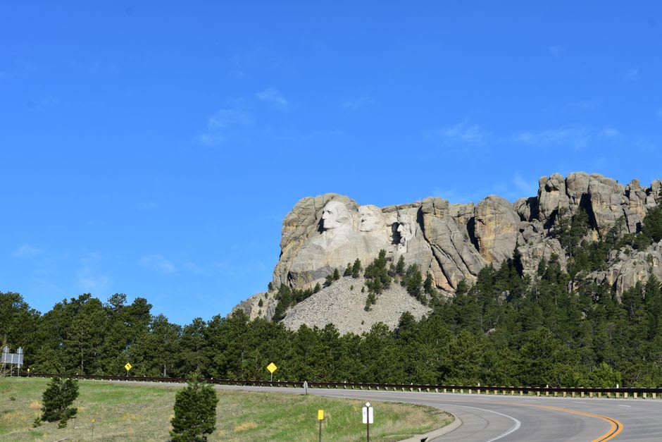 The illuminated faces of Mount Rushmore glowing against the night sky