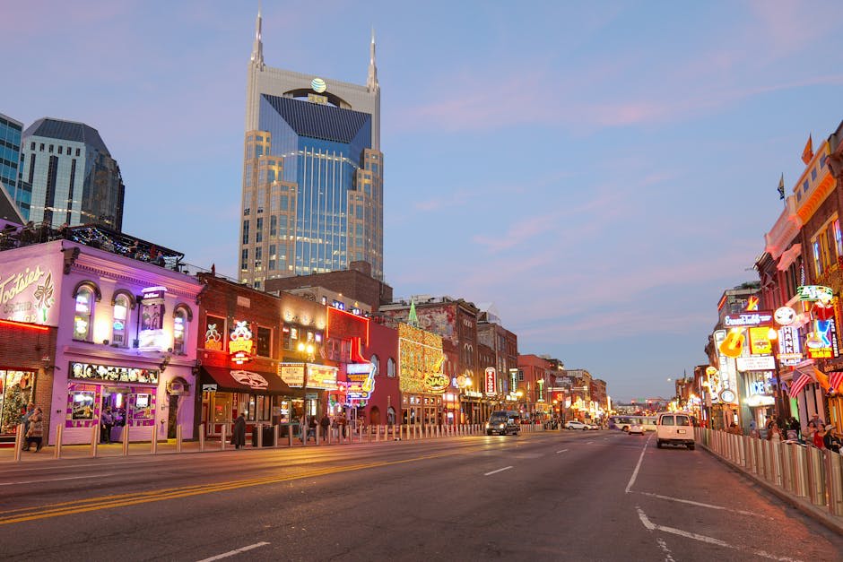 Neon honky-tonk signs glowing along Nashville's Broadway at night