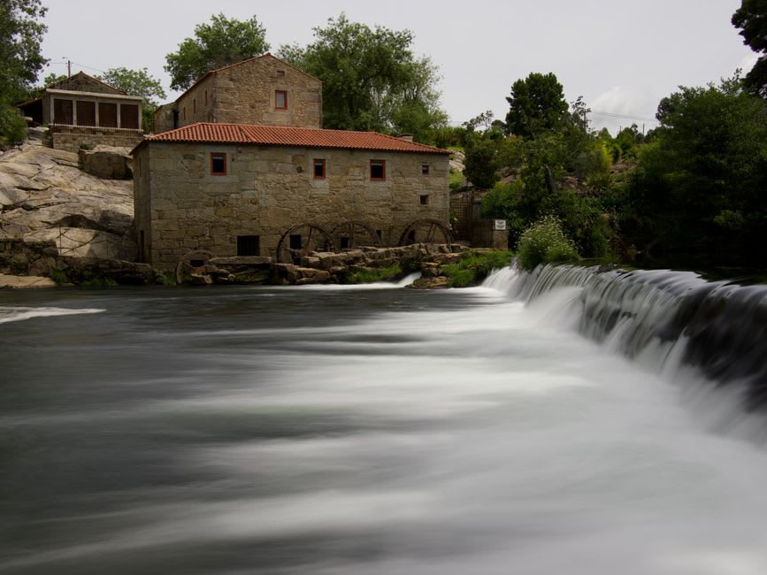 Yantic Falls cascading over granite ledges behind old mill buildings in Norwich, Connecticut