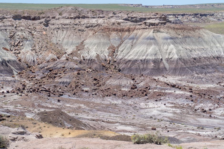 Striped badlands of the Painted Desert in lavender and rust under a wide sky