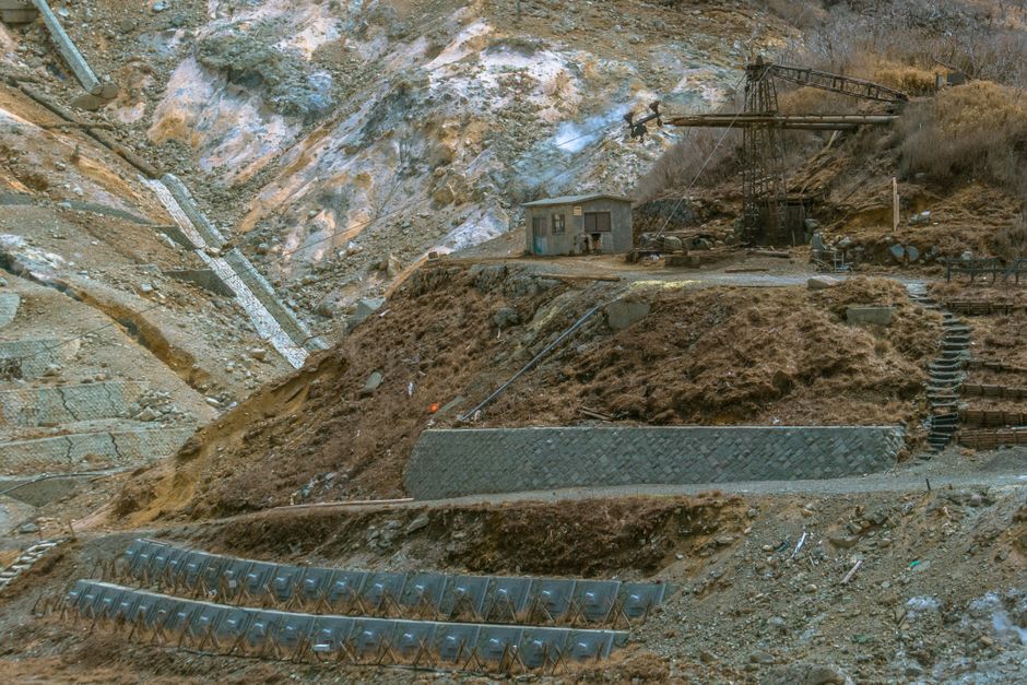 Rusted ore buckets hanging from the abandoned aerial tramway above Pioche, Nevada
